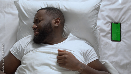 Wallpaper Mural Scared afro-american man hiding under blanket, fear of dark, loneliness, topview Torontodigital.ca