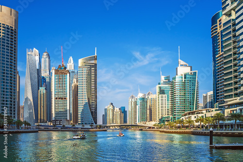 Dubai Marina canal with azure water and high rise buildings, United Arab Emirates. © DedMityay