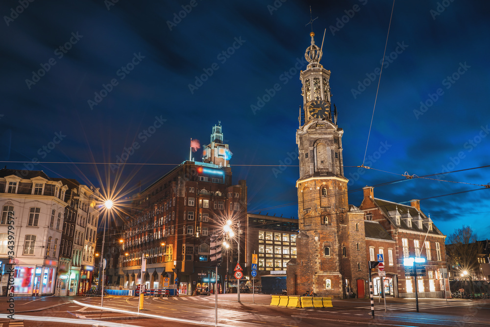 Munt Tower or Munttoren in Amsterdam historical center, night city, Netherlands.
