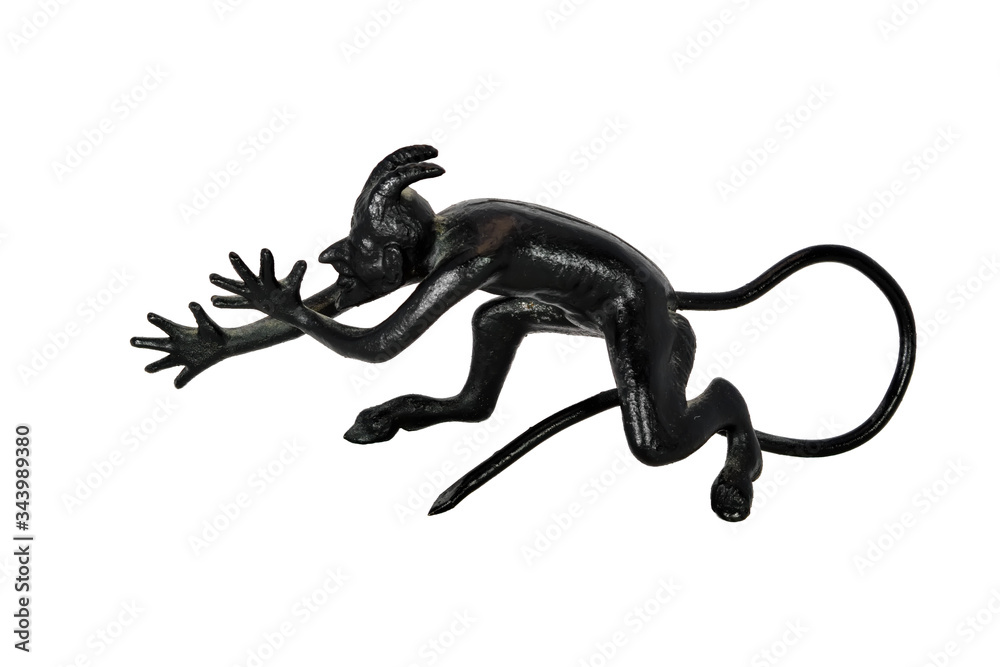 Cast-iron statuette of devil isolate on a white background close-up. Cast-iron statuette of devil isolate on a white background close-up.
