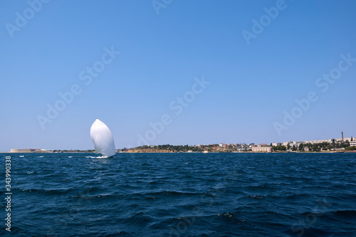 A yacht under white sails in the black sea. Sevastopol - August 9, 2016. photo