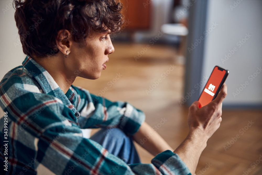 Handsome young man calling emergency from smartphone Handsome young man calling emergency from smartphone