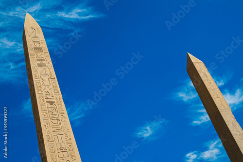 Fotografia two Obelisks  at the temple of Karnak in Luxor with hieroglyphic carvings on blu