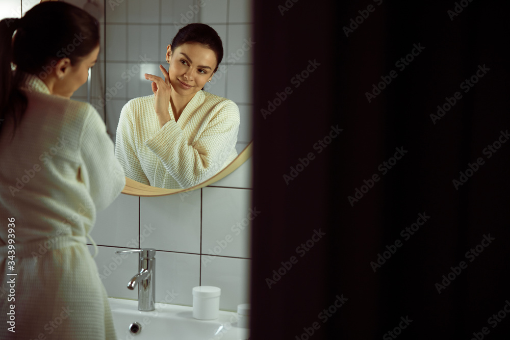Jolly girl standing in bathrobe stock photo Jolly girl standing in bathrobe stock photo