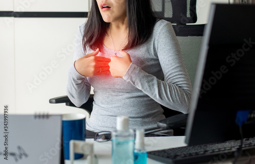 Obraz na płótnie Asian woman having or symptomatic reflux acids during working at home