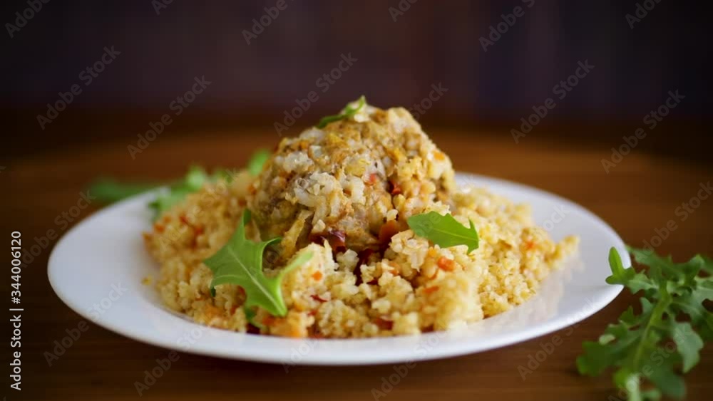 boiled bulgur groats with vegetables and meatballs in a plate boiled bulgur groats with vegetables and meatballs in a plate