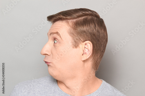 Portrait of blond mature man with fool goofy perplexed expression