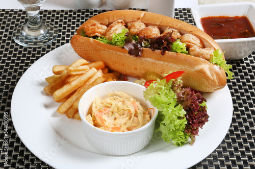 Shrimp prawns sandwich served with coleslaw and French Fries Potato fry pickle 