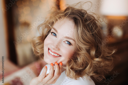 beautiful woman at home. A young girl in the interior of her apartment. The quarantined lady. Comfort and lifestyle.