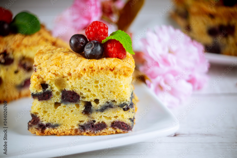 Piece of blueberry sour cream cake on white wooden background. Piece of blueberry sour cream cake on white wooden background.