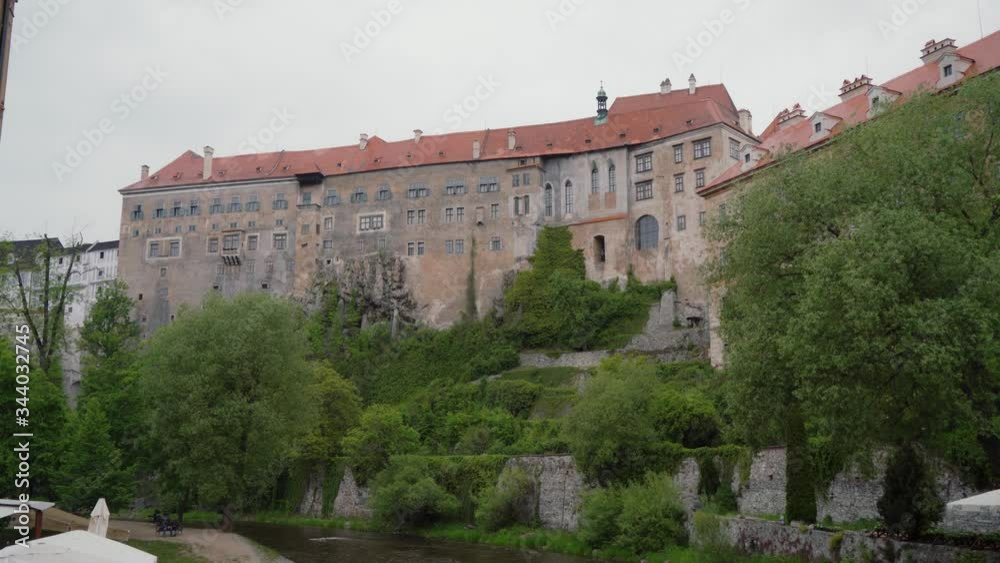 State Castle, Chateau Cesky Krumlov in Czech on cloudy spring day, green trees State Castle, Chateau Cesky Krumlov in Czech on cloudy spring day, green trees