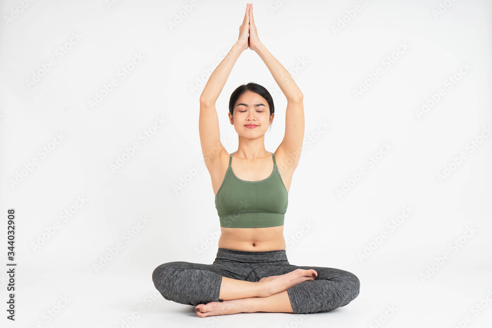 Fototapeta premium Young Asian woman yoga meditating on white background