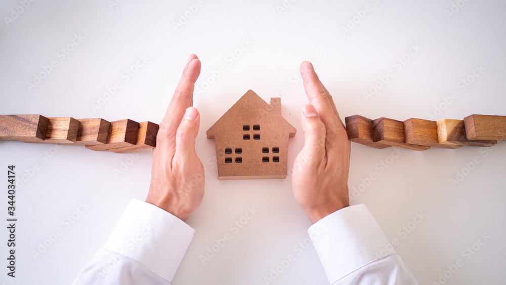 Fotografie insurance with hands protect a house