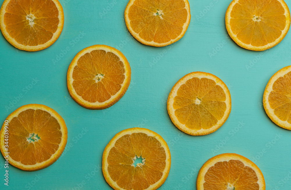 slices of orange on blue background,fruit pattern top view. slices of orange on blue background,fruit pattern top view.