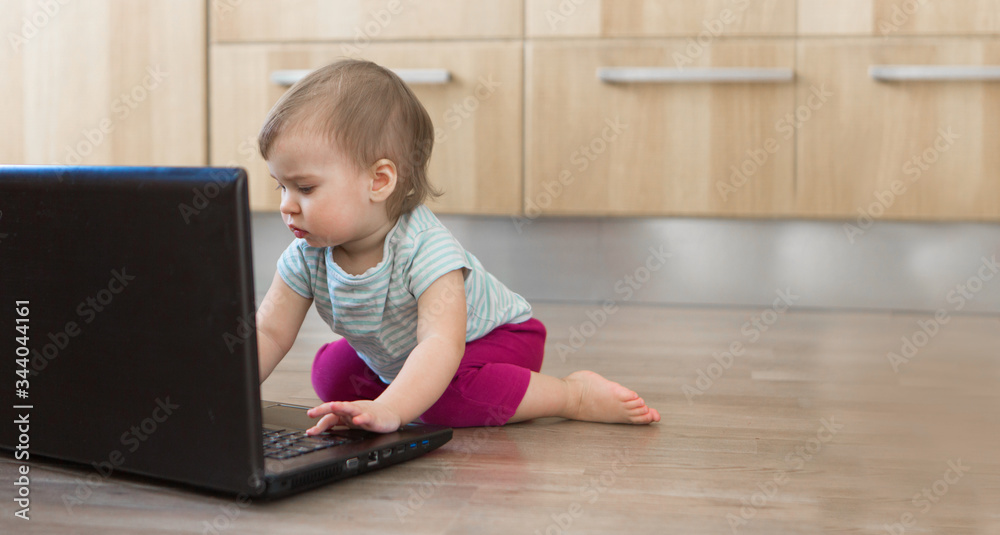 small child plays on computer. The child Prodigy learns the techniques of business Planning, home work, quarantine, self-isolation, protection from coronavirus, virus. Ordering products over Internet small child plays on computer. The child Prodigy learns the techniques of business Planning, home work, quarantine, self-isolation, protection from coronavirus, virus. Ordering products over Internet