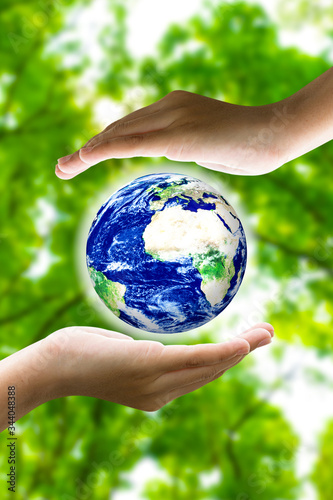 Woman hands holding world or globe on earth day.Environment conservation and energy saving concept.Elements of this image are furnished by NASA.