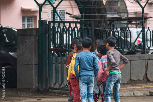 A group of poor children from different households gathering together and standing closely while violating social distancing and stay home norms during Covid 19 or corona virus outbreak in India. © PranayChandra
