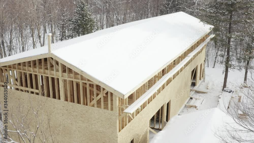 custom made wallpaper toronto digitalAerial zooming in view of frame house under construction surrounded with snowy forest
