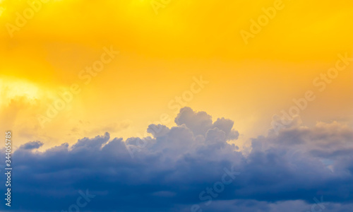 bright yellow sun light on sky with dim blue cloudy