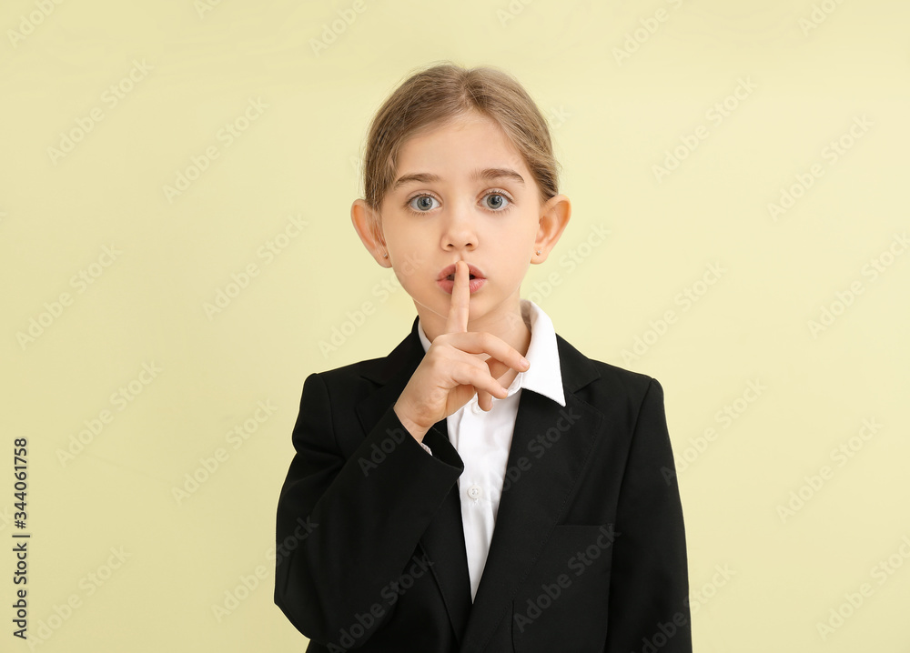 Little businesswoman showing silence gesture on color background Little businesswoman showing silence gesture on color background
