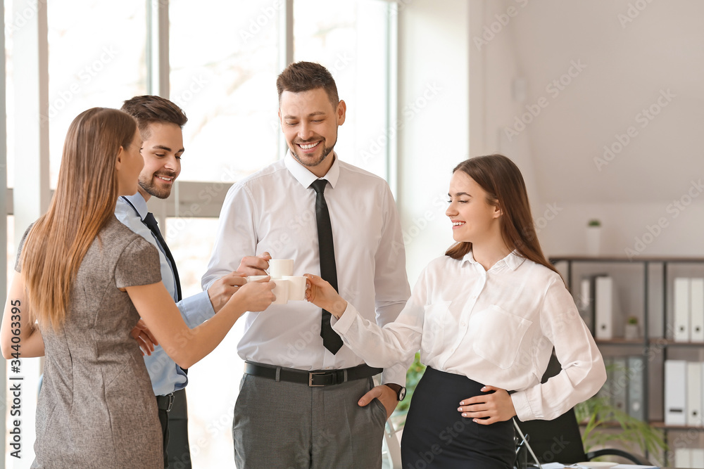 Colleagues drinking coffee in office Colleagues drinking coffee in office