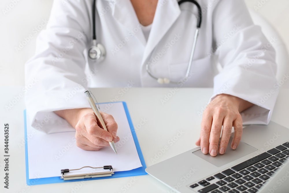 Mature female doctor working in clinic Mature female doctor working in clinic