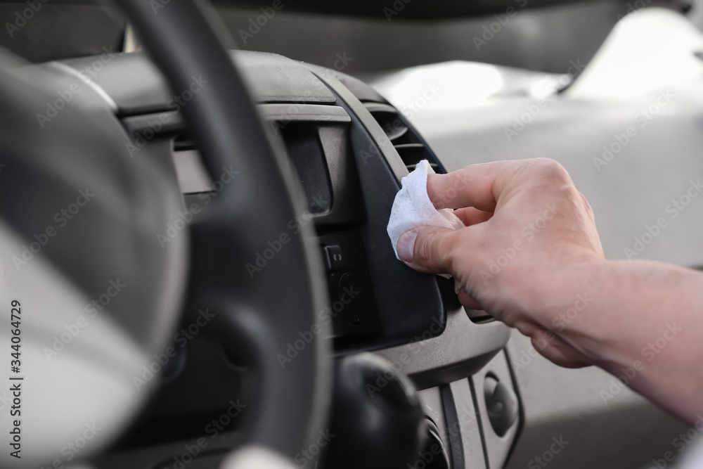 Man disinfecting salon of his car