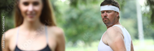 Man compares his figure with figure slender girl. Guy thinks about slim athletic body girl. After jogging people stay awake all day. Man feels pain in his back and neck. Guy heart rate increases