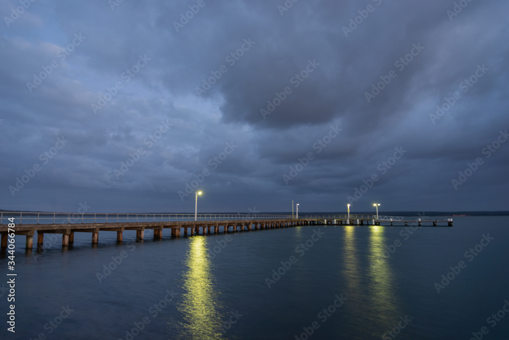 Corinella Pier early morning Dark clouds above Corinella Pier early morning Dark clouds above