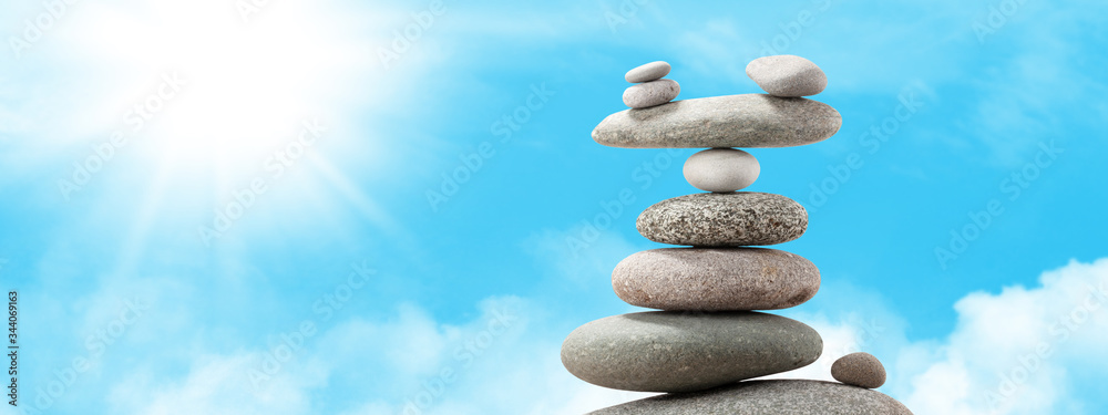 Pyramid of sea pebbles over a sunny sky Pyramid of sea pebbles over a sunny sky