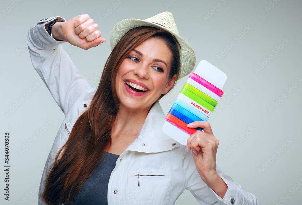 Happy woman wearing white jacket holding passport in raised hands. Happy woman wearing white jacket holding passport in raised hands.