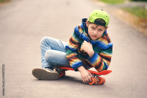 Young sportsman . Portrait of a boy with a skate on the street