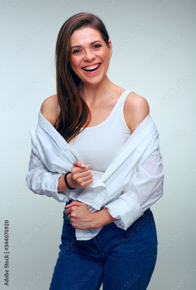 Smiling woman in casual clothes posing with naked shoulders. Smiling woman in casual clothes posing with naked shoulders.