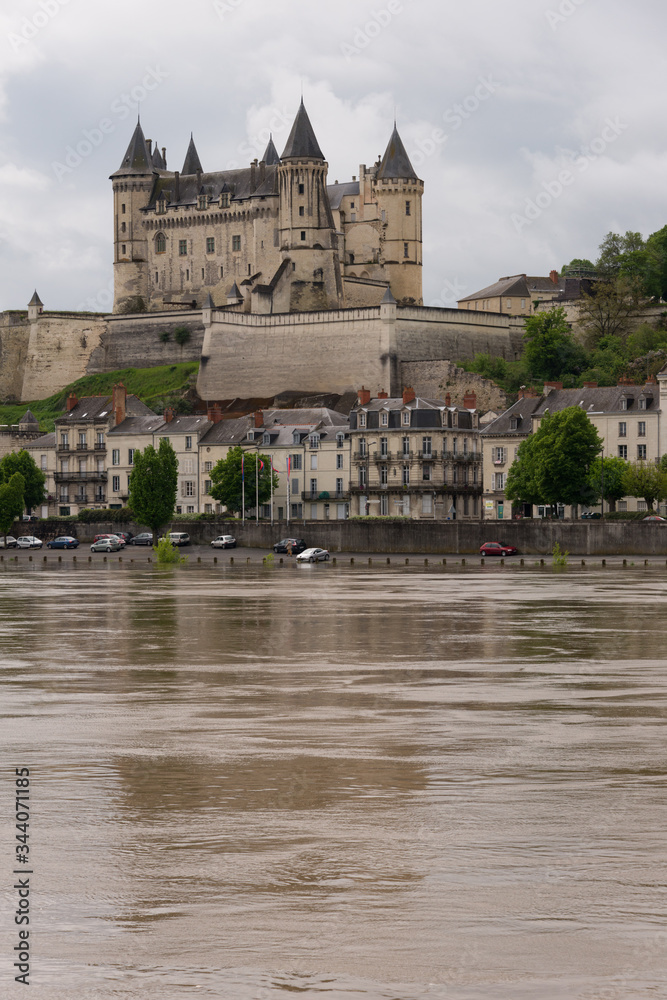 The chateau across a swollen Loire River at Saumur, France The chateau across a swollen Loire River at Saumur, France