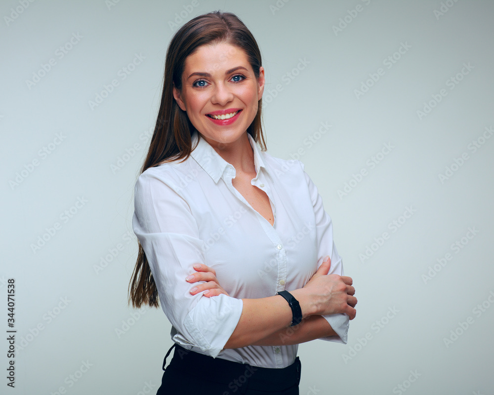 Smiling business woman in white shirt posing with crossed arms Smiling business woman in white shirt posing with crossed arms