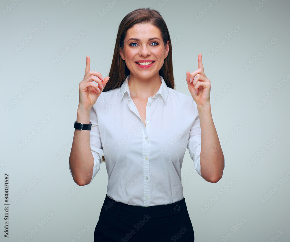 Smiling business woman in white shirt pointing up with finger Smiling business woman in white shirt pointing up with finger