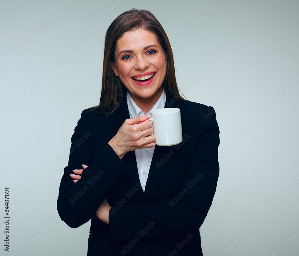 Laughing businesswoman in black suit holding white mug. Laughing businesswoman in black suit holding white mug.