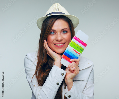 Close up face portrait of woman traveler holding passport with ticket.