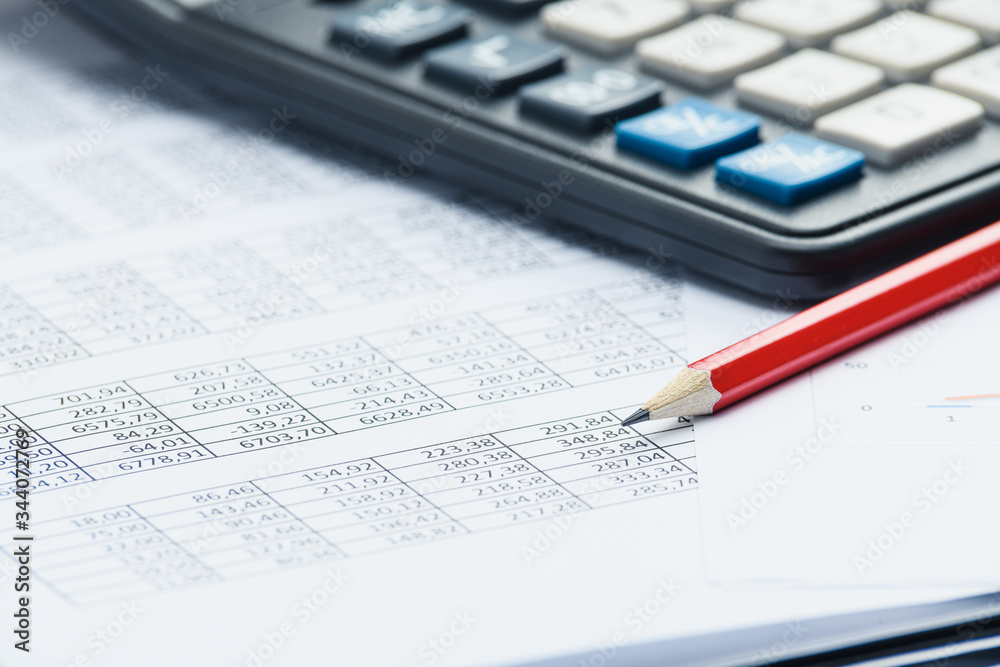Business financial documents, office calculator and pen on the table. Numbers and graphs Business financial documents, office calculator and pen on the table. Numbers and graphs