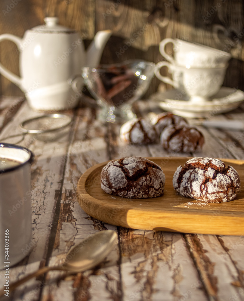 Chocolate cracked cookies decorated with icing sugar.