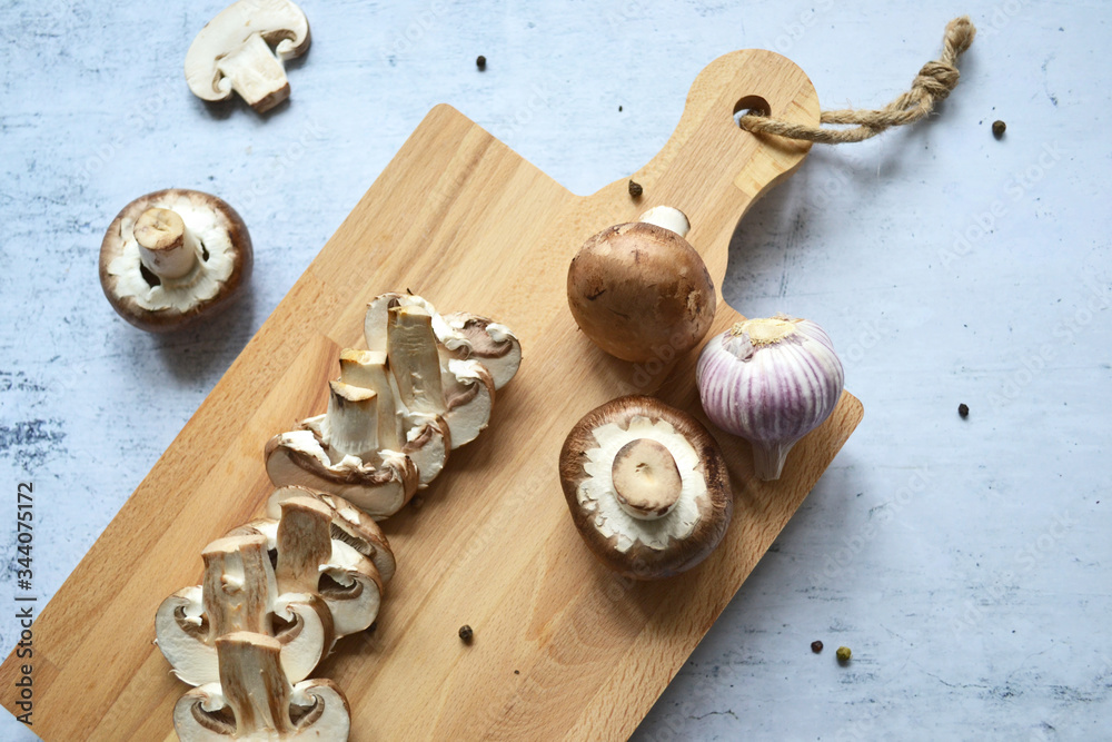 Fresh royal champignon mushrooms on a wooden board. View from above Fresh royal champignon mushrooms on a wooden board. View from above