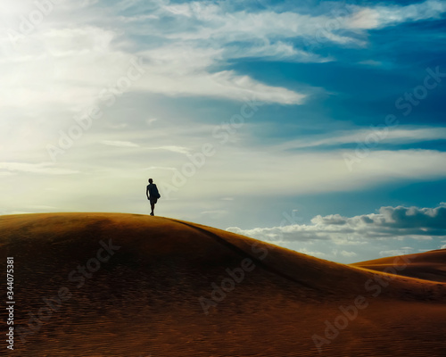 sandy desert. a man walks along a sandy desert