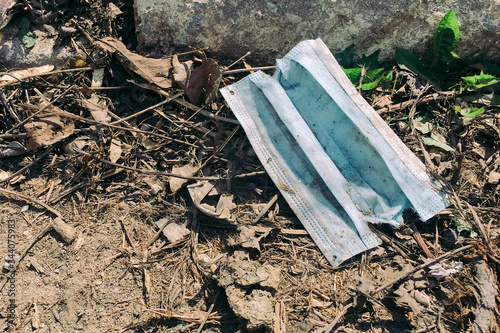 A used medical face mask dumped on the ground during the Covid-19 pandemic.