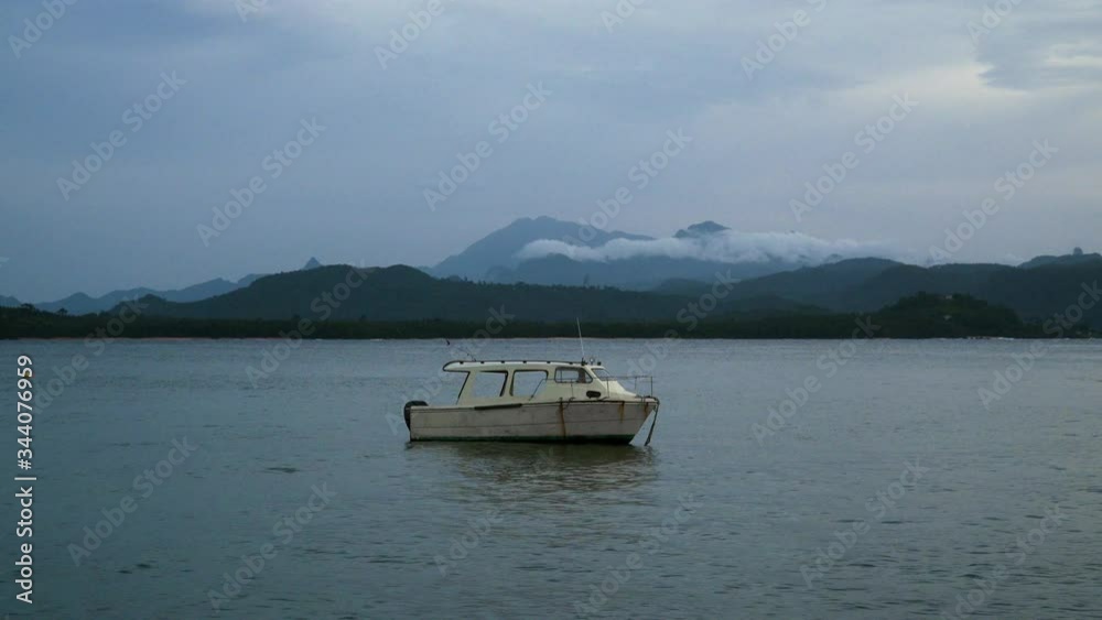 Tropical Lake landscape with a boat on the water Tropical Lake landscape with a boat on the water