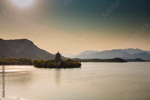 Chinese pagoda on an island, in the middle of water and mountains