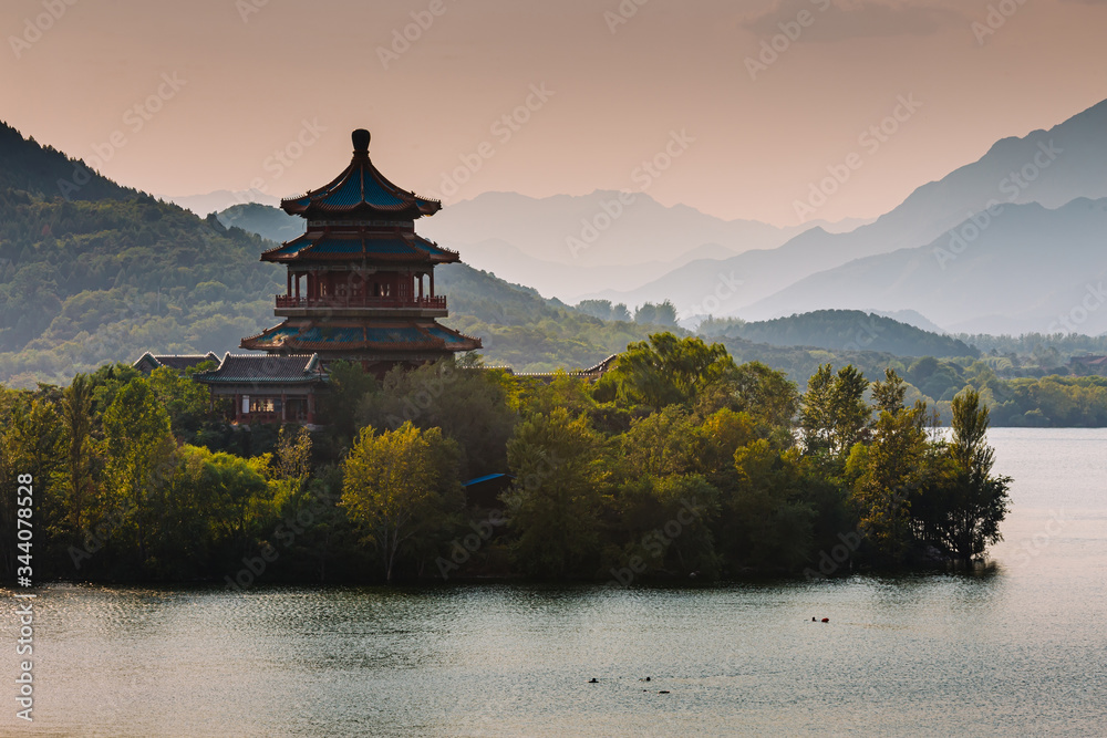 Chinese pagoda on an island, in the middle of water and mountains