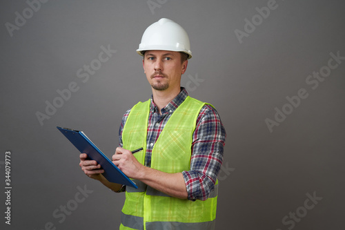 Worker man wearing protective hard hat and reflective vest.