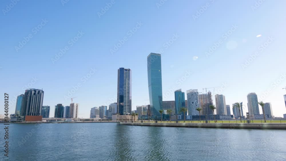 Picturesque view from lake water of park, cityscape and construction of new high rise building Picturesque view from lake water of park, cityscape and construction of new high rise building