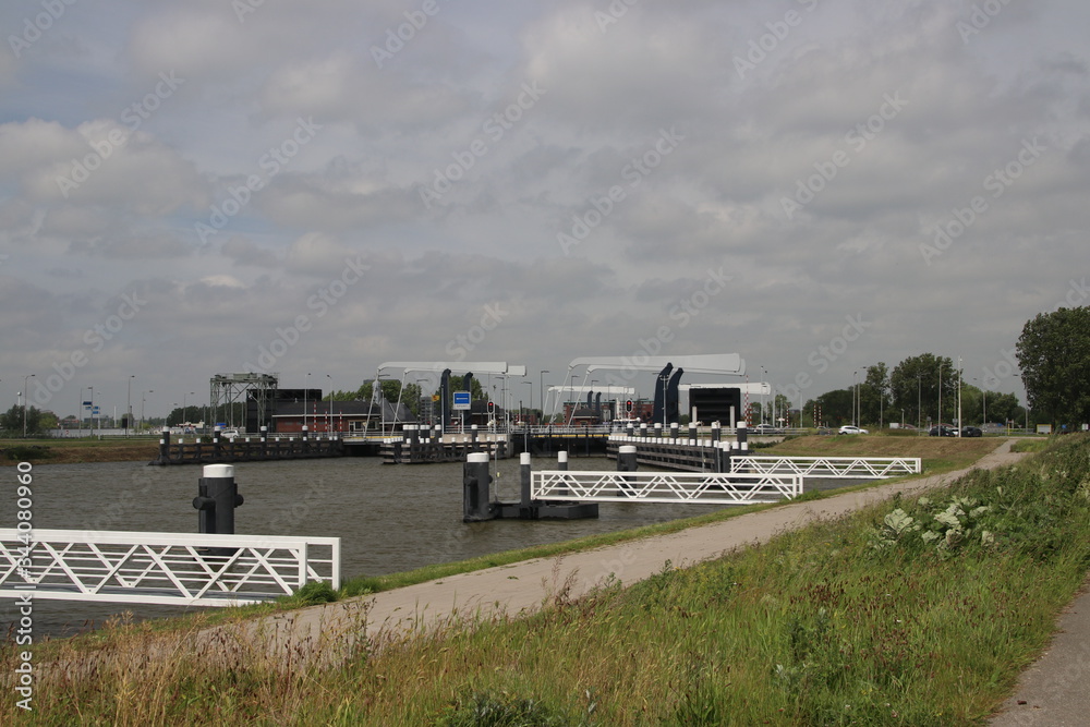 Mooring piers at the Hollandsche Ijssel river near the double sluice Julianasluis in Gouda in the Netherlands Mooring piers at the Hollandsche Ijssel river near the double sluice Julianasluis in Gouda in the Netherlands