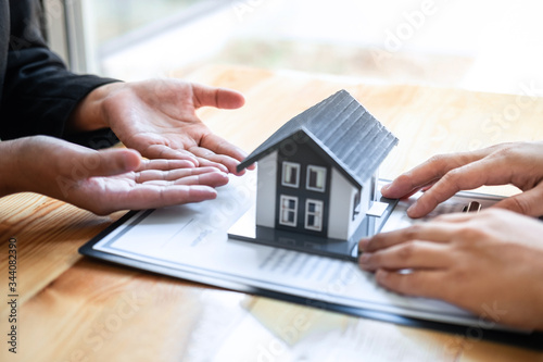 Estate agent are presenting home loan and giving house to client after discussing and signing agreement contract with approved application form, Home Insurance and Real estate investment concept